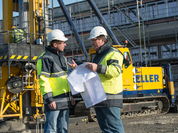 Employees on site discussing project
