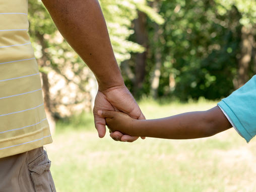 father and son holding hands